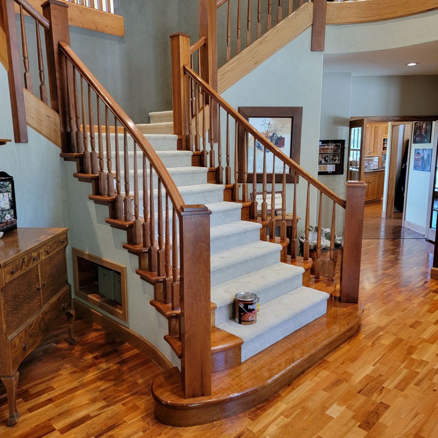Stained hardwood staircase, railings, and floors refinished by Midwest Paint and Stain